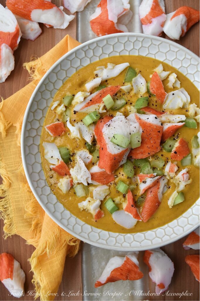 Creamy Cajun Sweet Potato Soup with Crab - Are you looking for a new and exciting twist on a traditional sweet potato soup recipe? Look no further than this Creamy Cajun Sweet Potato Soup with Crab. This delicious soup is bursting with flavor, thanks to a homemade seasoning blend that adds a spicy Cajun kick to its creamy sweet potato base. Topped with imitation crab meat and crunchy diced celery, this soup is sure to become a new spicy weeknight favorite.