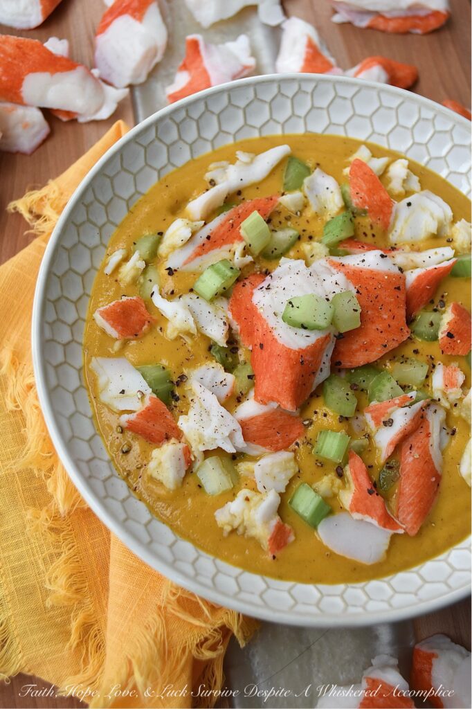 Creamy Cajun Sweet Potato Soup with Crab - Are you looking for a new and exciting twist on a traditional sweet potato soup recipe? Look no further than this Creamy Cajun Sweet Potato Soup with Crab. This delicious soup is bursting with flavor, thanks to a homemade seasoning blend that adds a spicy Cajun kick to its creamy sweet potato base. Topped with imitation crab meat and crunchy diced celery, this soup is sure to become a new spicy weeknight favorite.