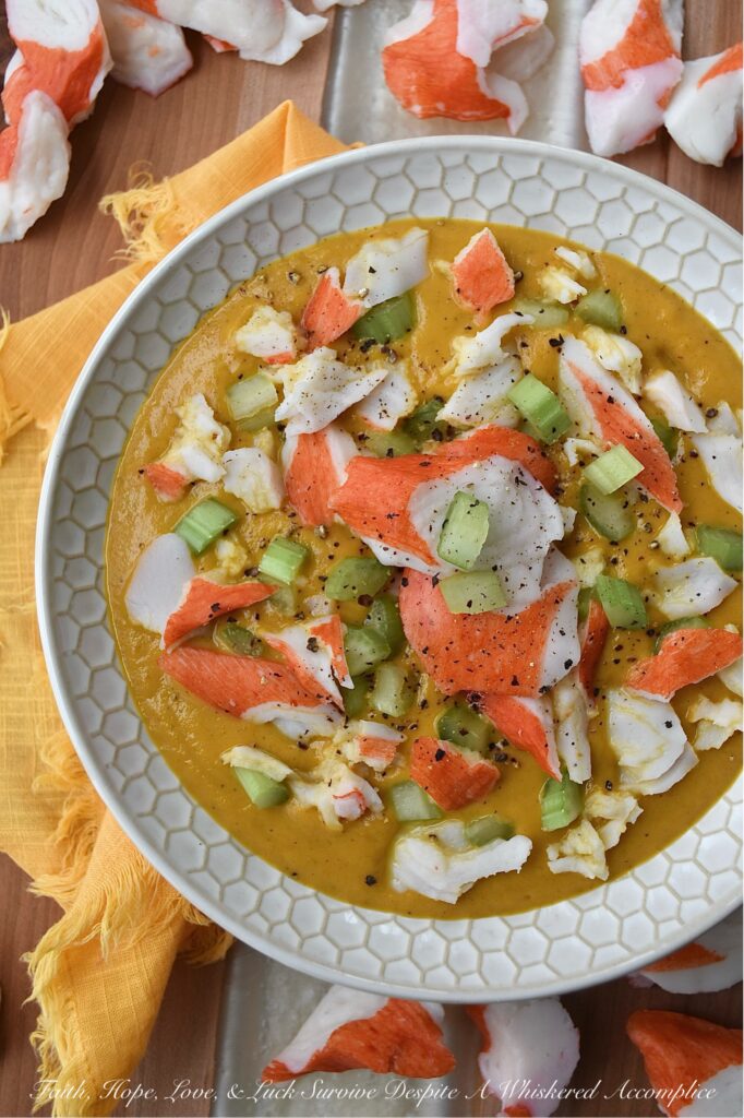 Creamy Cajun Sweet Potato Soup with Crab - Are you looking for a new and exciting twist on a traditional sweet potato soup recipe? Look no further than this Creamy Cajun Sweet Potato Soup with Crab. This delicious soup is bursting with flavor, thanks to a homemade seasoning blend that adds a spicy Cajun kick to its creamy sweet potato base. Topped with imitation crab meat and crunchy diced celery, this soup is sure to become a new spicy weeknight favorite.