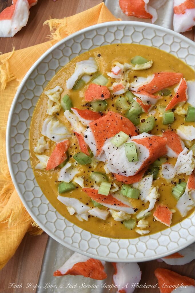 Creamy Cajun Sweet Potato Soup with Crab - Are you looking for a new and exciting twist on a traditional sweet potato soup recipe? Look no further than this Creamy Cajun Sweet Potato Soup with Crab. This delicious soup is bursting with flavor, thanks to a homemade seasoning blend that adds a spicy Cajun kick to its creamy sweet potato base. Topped with imitation crab meat and crunchy diced celery, this soup is sure to become a new spicy weeknight favorite.