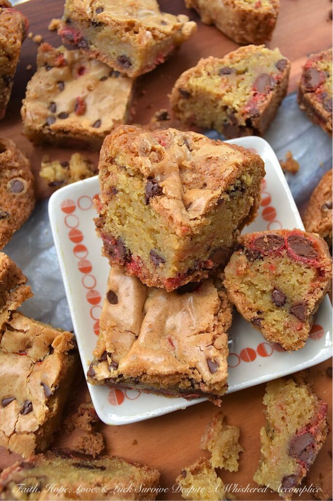 Chocolate Chip Cookie Blondies with M&M's - Get ready to satisfy your sweet tooth with these irresistible chocolate chip cookie blondies. These delicious bar cookies are the perfect sweet treat, boasting a soft and gooey center with thick, baked crunchy edges. And, since these blondies are so easy to customize with seasonal M&M's, they're an excellent festive dessert option for almost any occasion.