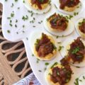 Deviled Eggs with Bourbon & Onion Bacon Jam - Get ready to wow your friends and family with this irresistible deviled egg recipe that is anything but traditional. By adding a sweet, salty, smoky, tangy, and slightly boozy bourbon and onion bacon jam, you can take your deviled eggs to the next level. The combination of rich, salty bacon, sweet yellow onions, smoky chili powder, and a touch of maple syrup and brown sugar creates an over-the-top flavor profile that is sure to impress. And with the addition of onion powder and chives to the egg filling, these deviled eggs are anything but boring with their oniony flavor.