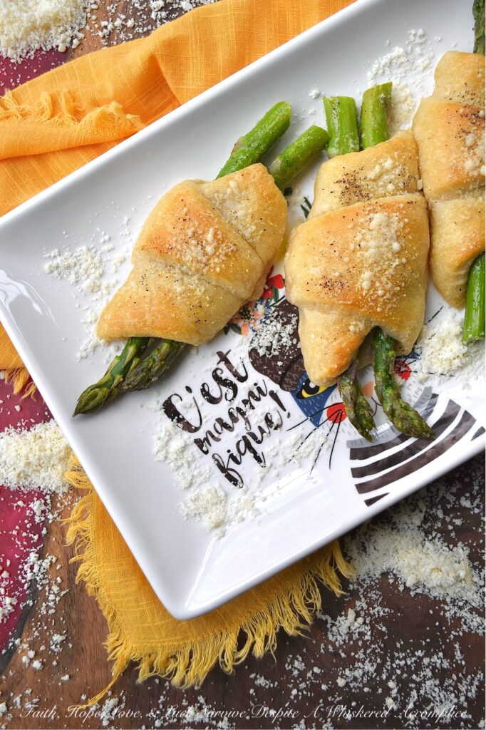 Crescent Wrapped Asparagus with Parmesan - This easy-t0-make recipe combines the fresh, crisp flavor of asparagus with the flaky, buttery goodness of a store-bought refrigerated crescent roll pastry and the slightly salty, cheesy, and nutty flavor of parmesan cheese. Whether enjoyed for breakfast alongside eggs or as a tasty accompaniment to a soup or salad for dinner, these Crescent Wrapped Asparagus with Parmesan are sure to be a hit.
