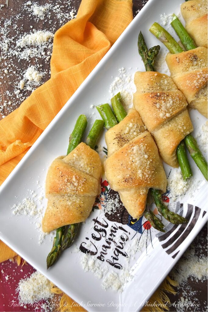 Crescent Wrapped Asparagus with Parmesan - This easy-t0-make recipe combines the fresh, crisp flavor of asparagus with the flaky, buttery goodness of a store-bought refrigerated crescent roll pastry and the slightly salty, cheesy, and nutty flavor of parmesan cheese. Whether enjoyed for breakfast alongside eggs or as a tasty accompaniment to a soup or salad for dinner, these Crescent Wrapped Asparagus with Parmesan are sure to be a hit.