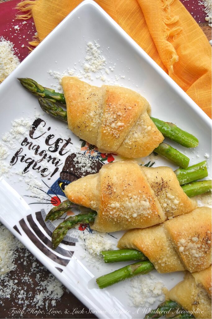 Crescent Wrapped Asparagus with Parmesan - This easy-t0-make recipe combines the fresh, crisp flavor of asparagus with the flaky, buttery goodness of a store-bought refrigerated crescent roll pastry and the slightly salty, cheesy, and nutty flavor of parmesan cheese. Whether enjoyed for breakfast alongside eggs or as a tasty accompaniment to a soup or salad for dinner, these Crescent Wrapped Asparagus with Parmesan are sure to be a hit.