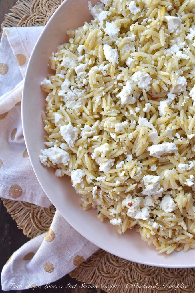 Orange & Feta Italian Orzo Pasta Salad - This simple orzo pasta salad is the perfect side dish to complement almost any meal. It's quick and easy to make, is neither too dry nor too oily, and has a bright orange citrusy flavor that pairs so well with its flavorful Italian dressing. A generous amount of feta cheese is the final touch to making this pasta salad incredibly delicious and irresistible.