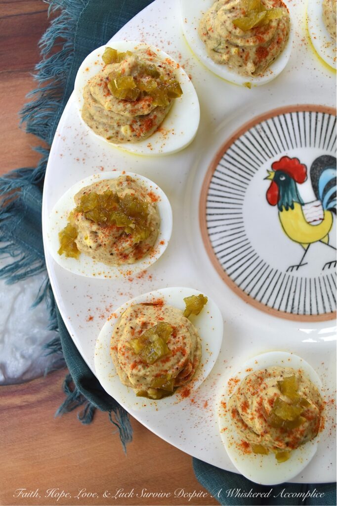 Candied Jalapeño Taco Seasoning Deviled Eggs - This kicked-up sweet and spicy deviled egg recipe is overflowing with a tremendously flavorful taco seasoning, ground cumin, and candied jalapeño filling. Garnished with a generous sprinkling of sweet paprika and more finely chopped candied jalapeños, these deviled eggs are almost impossible to resist. A little bit of taco seasoning goes a long way when it comes to this recipe. These deviled eggs, without a doubt, will become a frequently requested deviled egg appetizer for every party or barbeque you attend. They're so good, that you might want to just go ahead and make a double batch.