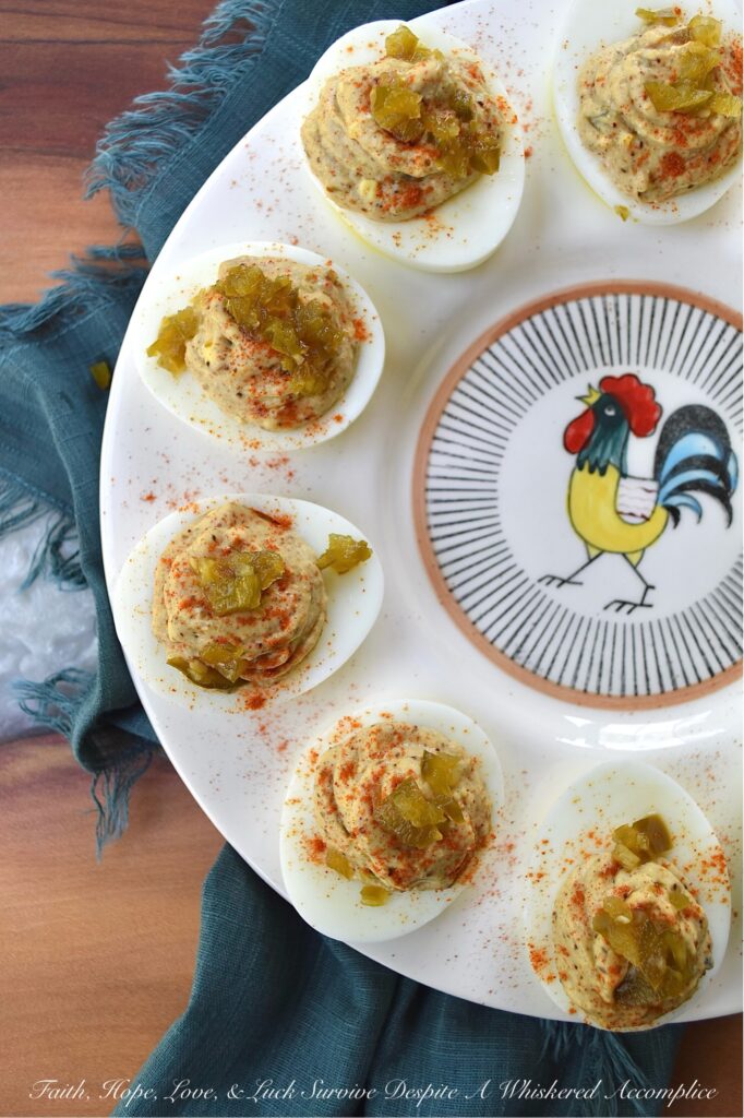 Candied Jalapeño Taco Seasoning Deviled Eggs - This kicked-up sweet and spicy deviled egg recipe is overflowing with a tremendously flavorful taco seasoning, ground cumin, and candied jalapeño filling. Garnished with a generous sprinkling of sweet paprika and more finely chopped candied jalapeños, these deviled eggs are almost impossible to resist. A little bit of taco seasoning goes a long way when it comes to this recipe. These deviled eggs, without a doubt, will become a frequently requested deviled egg appetizer for every party or barbeque you attend. They're so good, that you might want to just go ahead and make a double batch.