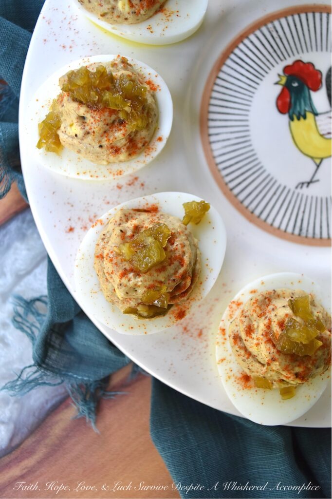 Candied Jalapeño Taco Seasoning Deviled Eggs - This kicked-up sweet and spicy deviled egg recipe is overflowing with a tremendously flavorful taco seasoning, ground cumin, and candied jalapeño filling. Garnished with a generous sprinkling of sweet paprika and more finely chopped candied jalapeños, these deviled eggs are almost impossible to resist. A little bit of taco seasoning goes a long way when it comes to this recipe. These deviled eggs, without a doubt, will become a frequently requested deviled egg appetizer for every party or barbeque you attend. They're so good, that you might want to just go ahead and make a double batch.