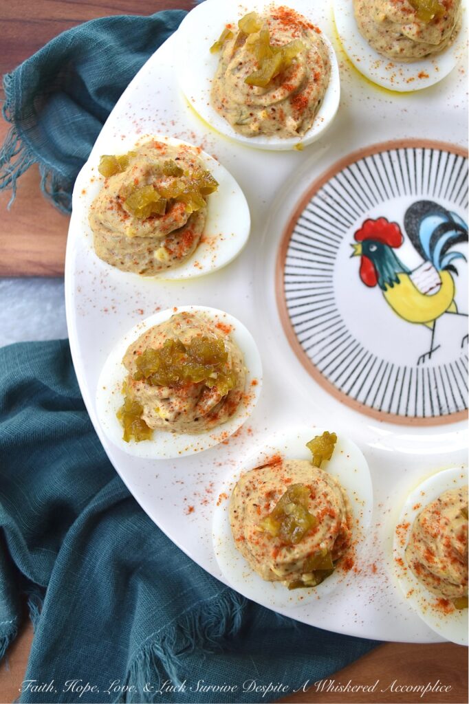 Candied Jalapeño Taco Seasoning Deviled Eggs - This kicked-up sweet and spicy deviled egg recipe is overflowing with a tremendously flavorful taco seasoning, ground cumin, and candied jalapeño filling. Garnished with a generous sprinkling of sweet paprika and more finely chopped candied jalapeños, these deviled eggs are almost impossible to resist. A little bit of taco seasoning goes a long way when it comes to this recipe. These deviled eggs, without a doubt, will become a frequently requested deviled egg appetizer for every party or barbeque you attend. They're so good, that you might want to just go ahead and make a double batch.