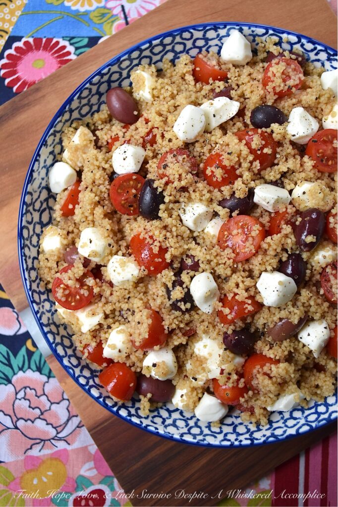 Kalamata, Mozzarella, & Tomato Couscous Salad - Looking for an easy and satisfying pasta side dish? Try this fluffy wheat couscous salad with tangy Kalamata olives, juicy cherry or grape tomatoes, and creamy fresh mozzarella pearls. With minimal time and effort, you can create a substantial pasta salad that is perfect for any occasion. Plus, it's easy to stretch out to serve larger crowds by simply adding fresh vegetables or Italian deli meat to the mix.