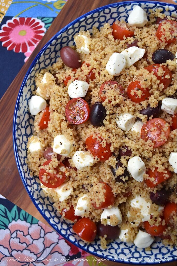 Kalamata, Mozzarella, & Tomato Couscous Salad - Looking for an easy and satisfying pasta side dish? Try this fluffy wheat couscous salad with tangy Kalamata olives, juicy cherry or grape tomatoes, and creamy fresh mozzarella pearls. With minimal time and effort, you can create a substantial pasta salad that is perfect for any occasion. Plus, it's easy to stretch out to serve larger crowds by simply adding fresh vegetables or Italian deli meat to the mix.