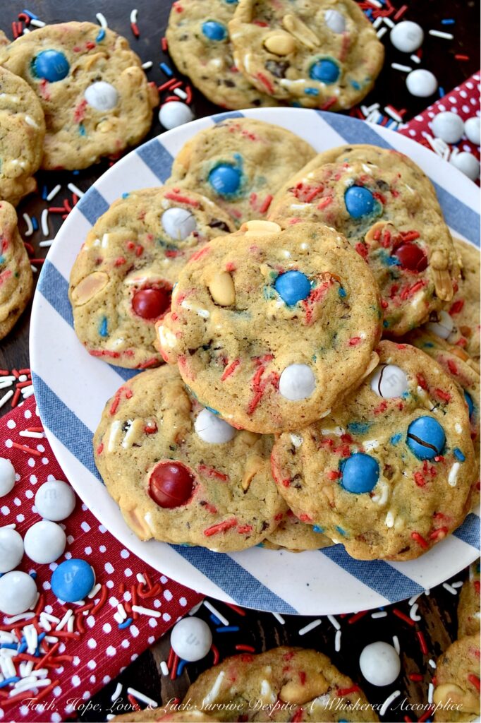 Summertime Cookies with Peanut Butter M&M's - Picture this, a soft and chewy brown sugar cookie, infused with the irresistible crunch of chunky salted cocktail peanuts and the colorful sweet burst of Peanut Butter M&M's. But wait, there's more. These cookies are just as colorful, festive, and enticing as they are delicious. With the addition of colorful summertime sprinkles, these attractively irresistible cookies are destined to become a real crowd-pleaser, whether served at your next barbecue, picnic, or summer vacation pool party.
