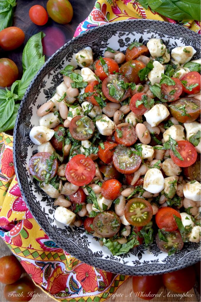 Great Northern Bean Summer Caprese Salad - Caprese salad, with its seasonal ingredients, vibrant colors, and refreshing flavors, is a classic summertime staple. This easy-to-assemble great northern bean salad is made with fresh basil, sun-ripened tomatoes, and creamy fresh mozzarella pearls. For a twist on the traditional recipe, try this no-cook bean salad that combines canned great northern beans with classic Caprese salad ingredients. Not only does this flavorful side dish complement most summer meals, but it also helps keep your kitchen cool during the hot and humid months of summer.