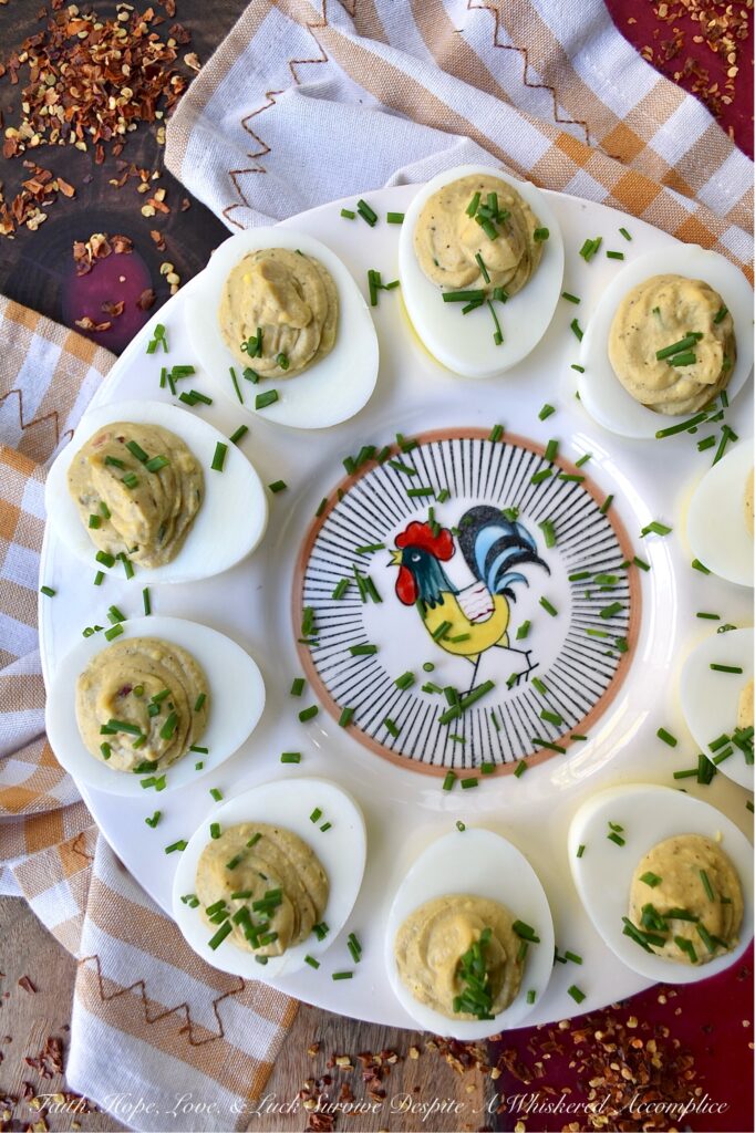 Sweet & Spicy Balsamic Vinegar Deviled Eggs - This recipe elevates traditional deviled eggs by incorporating tangy balsamic vinegar, a touch of sugar, and a kick from crushed red pepper flakes, creating a sweet and spicy appetizer that's sure to be an instant crowd-pleaser. Freshly chopped chives not only add a vibrant burst of color but also provide a refreshing onion flavor that perfectly complements the rich, creamy, sweet, and spicy balsamic vinegar deviled egg filling.