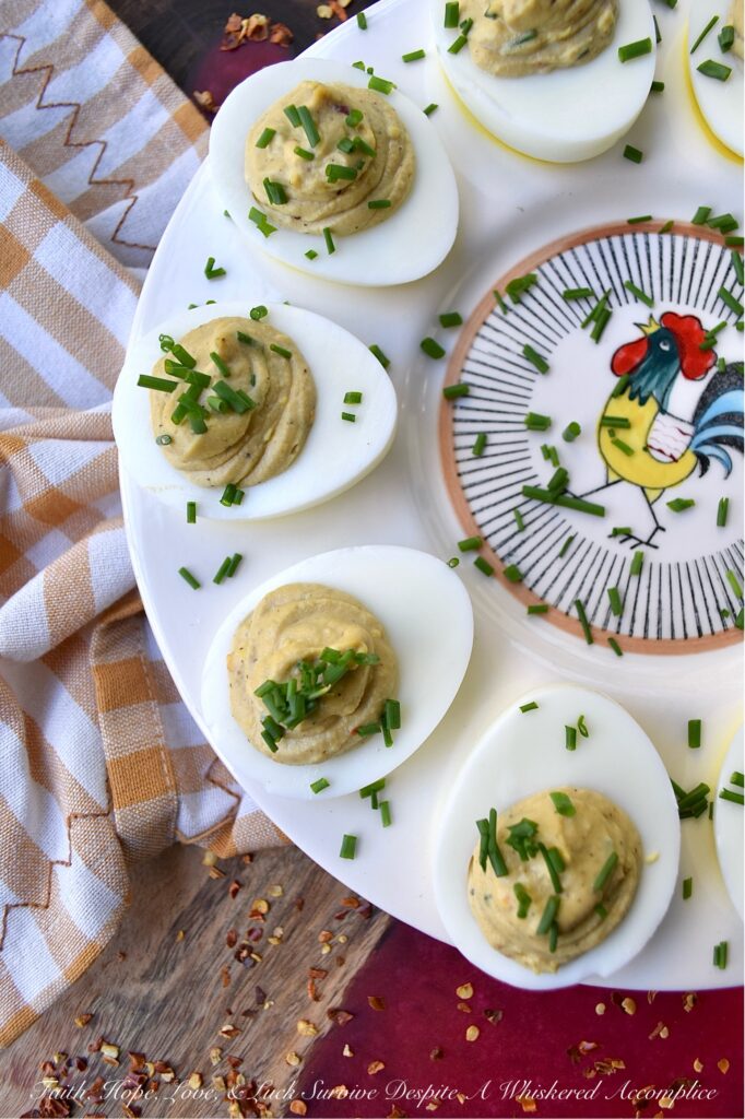 Sweet & Spicy Balsamic Vinegar Deviled Eggs - This recipe elevates traditional deviled eggs by incorporating tangy balsamic vinegar, a touch of sugar, and a kick from crushed red pepper flakes, creating a sweet and spicy appetizer that's sure to be an instant crowd-pleaser. Freshly chopped chives not only add a vibrant burst of color but also provide a refreshing onion flavor that perfectly complements the rich, creamy, sweet, and spicy balsamic vinegar deviled egg filling.