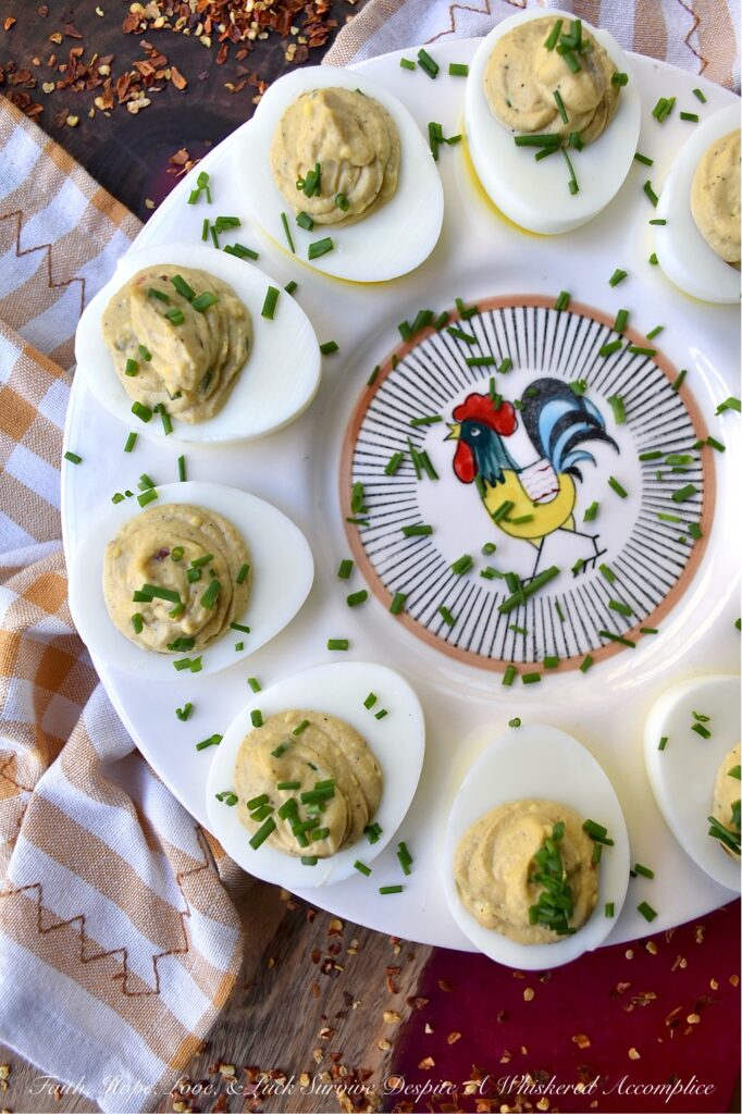 Sweet & Spicy Balsamic Vinegar Deviled Eggs - This recipe elevates traditional deviled eggs by incorporating tangy balsamic vinegar, a touch of sugar, and a kick from crushed red pepper flakes, creating a sweet and spicy appetizer that's sure to be an instant crowd-pleaser. Freshly chopped chives not only add a vibrant burst of color but also provide a refreshing onion flavor that perfectly complements the rich, creamy, sweet, and spicy balsamic vinegar deviled egg filling.