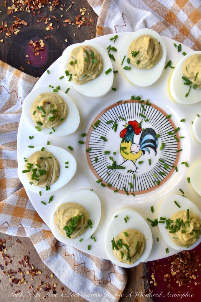 Sweet & Spicy Balsamic Vinegar Deviled Eggs - This recipe elevates traditional deviled eggs by incorporating tangy balsamic vinegar, a touch of sugar, and a kick from crushed red pepper flakes, creating a sweet and spicy appetizer that's sure to be an instant crowd-pleaser. Freshly chopped chives not only add a vibrant burst of color but also provide a refreshing onion flavor that perfectly complements the rich, creamy, sweet, and spicy balsamic vinegar deviled egg filling.