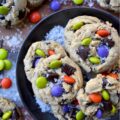 Oatmeal M&M Salted Chocolate Chunk Cookies - Imagine biting into a warm, chewy baked cookie that combines just the right hint of oatmeal and rich, luscious chocolate chunks, along with decorative and colorful M&M’s to add a pop of color and a playful crunch. A sprinkle of fleur de sel or flaky sea salt helps to add that little something extra, creating a sweet and salty combination that is simply irresistible. These salted chocolate chunk cookies with oatmeal and M&M's are the perfect treat to brighten any day, no matter the season.