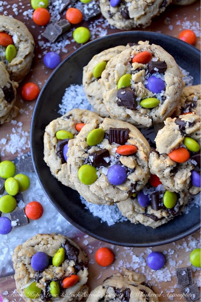 Oatmeal M&M Salted Chocolate Chunk Cookies - Imagine biting into a warm, chewy baked cookie that combines just the right hint of oatmeal and rich, luscious chocolate chunks, along with decorative and colorful M&M’s to add a pop of color and a playful crunch. A sprinkle of fleur de sel or flaky sea salt helps to add that little something extra, creating a sweet and salty combination that is simply irresistible. These salted chocolate chunk cookies with oatmeal and M&M's are the perfect treat to brighten any day, no matter the season.