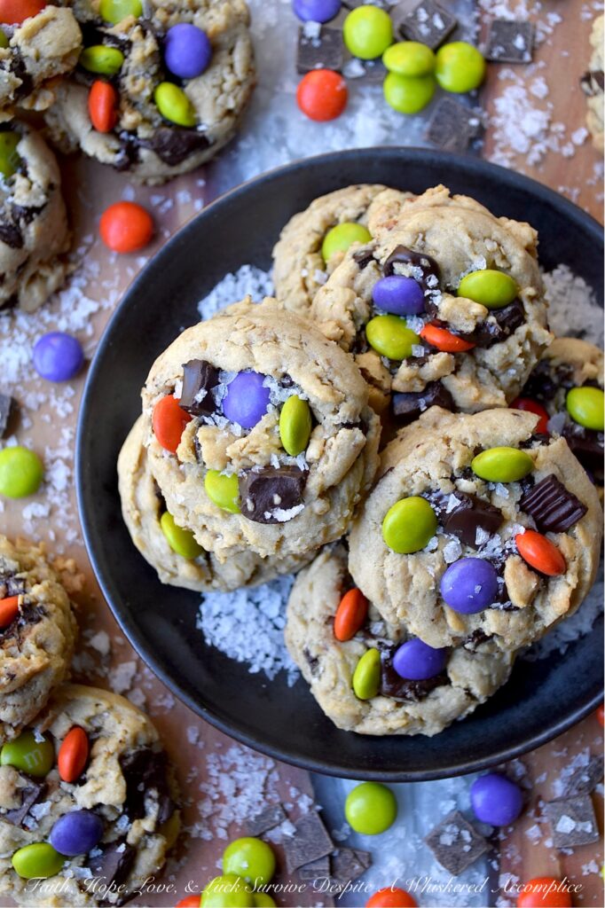 Oatmeal M&M Salted Chocolate Chunk Cookies - Imagine biting into a warm, chewy baked cookie that combines just the right hint of oatmeal and rich, luscious chocolate chunks, along with decorative and colorful M&M’s to add a pop of color and a playful crunch. A sprinkle of fleur de sel or flaky sea salt helps to add that little something extra, creating a sweet and salty combination that is simply irresistible. These salted chocolate chunk cookies with oatmeal and M&M's are the perfect treat to brighten any day, no matter the season.