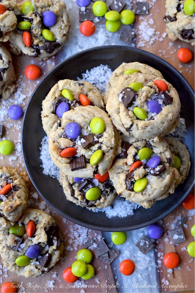 Oatmeal M&M Salted Chocolate Chunk Cookies - Imagine biting into a warm, chewy baked cookie that combines just the right hint of oatmeal and rich, luscious chocolate chunks, along with decorative and colorful M&M’s to add a pop of color and a playful crunch. A sprinkle of fleur de sel or flaky sea salt helps to add that little something extra, creating a sweet and salty combination that is simply irresistible. These salted chocolate chunk cookies with oatmeal and M&M's are the perfect treat to brighten any day, no matter the season.
