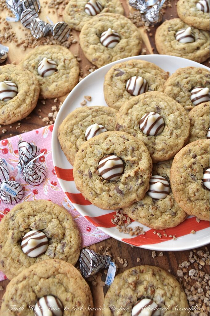 X's & O's (Hugs & Kisses) Brown Sugar Cookies - Nothing quite compares to the warmth of a hug or the sweetness of a kiss, and with these X's & O's Brown Sugar Cookies, you won't have to choose between the two. These cookies are topped with Hershey's Hugs and infused with the rich, melty goodness of roughly chopped Milk Chocolate Hershey’s Kisses. The unexpected addition of Grape Nuts cereal gives these buttery, crunchy, and chocolatey hugs and kisses cookies a delightful twist that makes them almost impossible not to fall head over heels in love with.