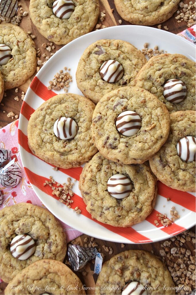 X's & O's (Hugs & Kisses) Brown Sugar Cookies - Nothing quite compares to the warmth of a hug or the sweetness of a kiss, and with these X's & O's Brown Sugar Cookies, you won't have to choose between the two. These cookies are topped with Hershey's Hugs and infused with the rich, melty goodness of roughly chopped Milk Chocolate Hershey’s Kisses. The unexpected addition of Grape Nuts cereal gives these buttery, crunchy, and chocolatey hugs and kisses cookies a delightful twist that makes them almost impossible not to fall head over heels in love with.