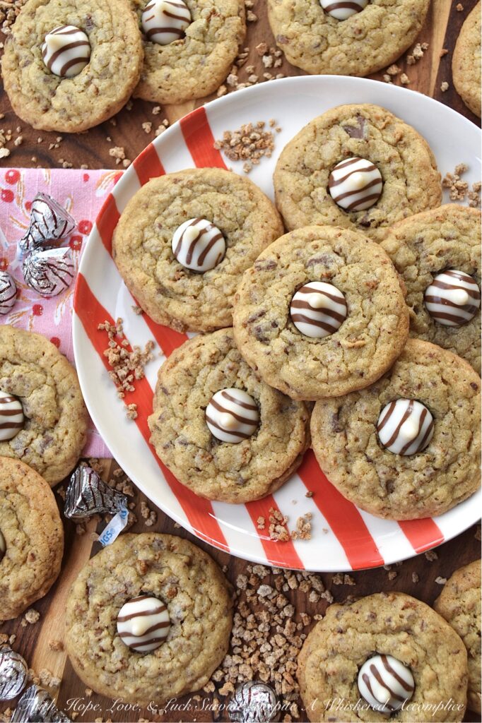 X's & O's (Hugs & Kisses) Brown Sugar Cookies - Nothing quite compares to the warmth of a hug or the sweetness of a kiss, and with these X's & O's Brown Sugar Cookies, you won't have to choose between the two. These cookies are topped with Hershey's Hugs and infused with the rich, melty goodness of roughly chopped Milk Chocolate Hershey’s Kisses. The unexpected addition of Grape Nuts cereal gives these buttery, crunchy, and chocolatey hugs and kisses cookies a delightful twist that makes them almost impossible not to fall head over heels in love with.