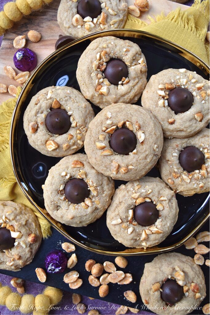 Honey Roasted Peanut Chocolate Kiss Cookies - This is a non-fussy, straightforward recipe, made with simple ingredients, that can most likely be found in your pantry. Chopped honey roasted peanuts and Hershey's Kisses give these soft and chewy brown sugar cookies a nutty, crunchy texture with a chocolatey decorative finish. This delightful cookie combo is sure to satisfy almost anyone's sweet tooth.