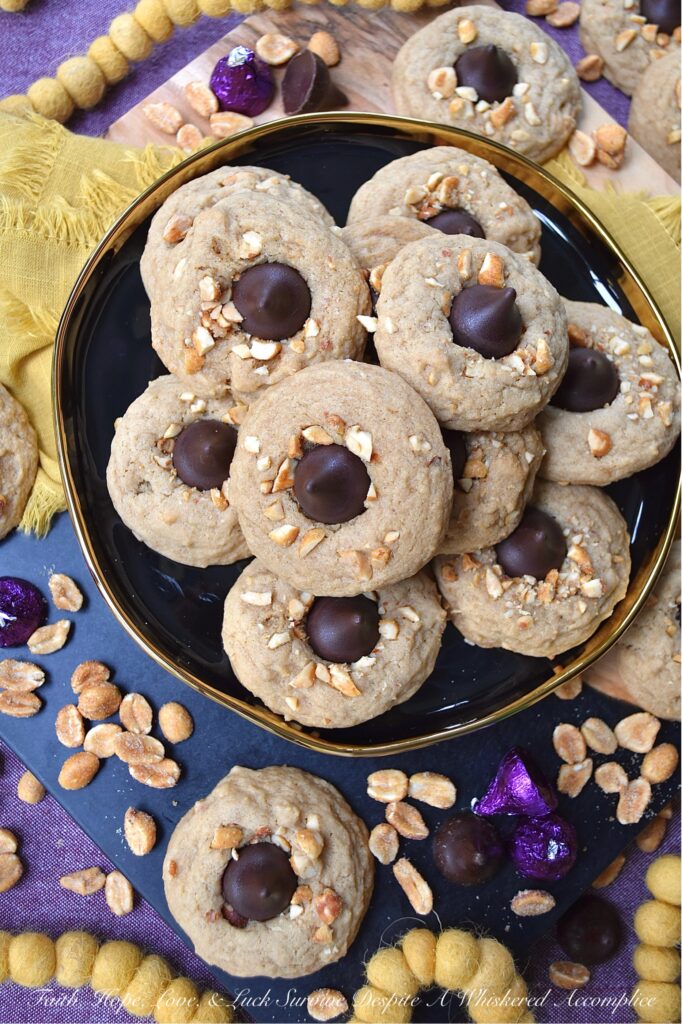 Honey Roasted Peanut Chocolate Kiss Cookies - This is a non-fussy, straightforward recipe, made with simple ingredients, that can most likely be found in your pantry. Chopped honey roasted peanuts and Hershey's Kisses give these soft and chewy brown sugar cookies a nutty, crunchy texture with a chocolatey decorative finish. This delightful cookie combo is sure to satisfy almost anyone's sweet tooth.
