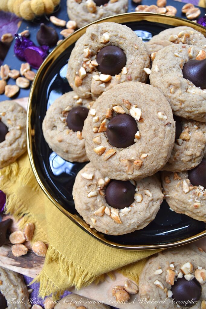 Honey Roasted Peanut Chocolate Kiss Cookies - This is a non-fussy, straightforward recipe, made with simple ingredients, that can most likely be found in your pantry. Chopped honey roasted peanuts and Hershey's Kisses give these soft and chewy brown sugar cookies a nutty, crunchy texture with a chocolatey decorative finish. This delightful cookie combo is sure to satisfy almost anyone's sweet tooth.