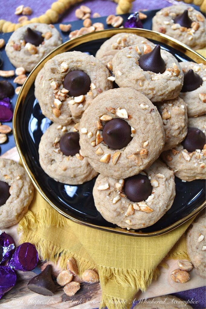 Honey Roasted Peanut Chocolate Kiss Cookies - This is a non-fussy, straightforward recipe, made with simple ingredients, that can most likely be found in your pantry. Chopped honey roasted peanuts and Hershey's Kisses give these soft and chewy brown sugar cookies a nutty, crunchy texture with a chocolatey decorative finish. This delightful cookie combo is sure to satisfy almost anyone's sweet tooth.
