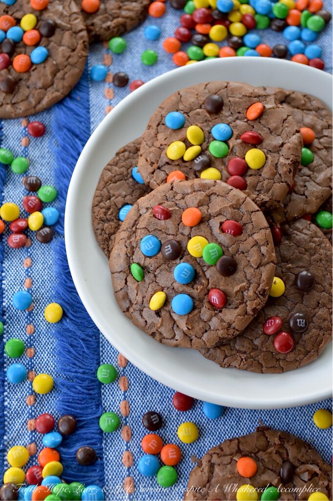 Chocolate Espresso Rainbow Brownie Cookies - Who says you have to choose between cookies and brownies when it’s time for dessert? These super-chocolatey cookies are thin, chewy, and oh-so-delicious, with a glossy, crackled finish that reminds you of your favorite brownies. A hint of espresso perfectly complements the rich chocolate cookie flavor, while vibrant Milk Chocolate M&M's Minis candies add a cheerful pop of rainbow color.