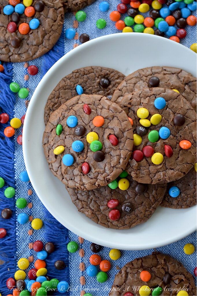 Chocolate Espresso Rainbow Brownie Cookies - Who says you have to choose between cookies and brownies when it’s time for dessert? These super-chocolatey cookies are thin, chewy, and oh-so-delicious, with a glossy, crackled finish that reminds you of your favorite brownies. A hint of espresso perfectly complements the rich chocolate cookie flavor, while vibrant Milk Chocolate M&M's Minis candies add a cheerful pop of rainbow color.