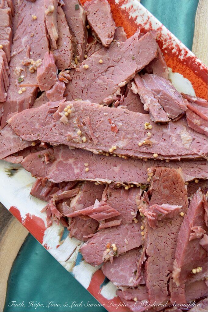 Guinness Stout Crockpot Simmered Corned Beef - Forget complicated recipes and wasted hours spent in the kitchen. With just five simple ingredients and the help of your trusty crockpot or slow cooker, you can transform a tough corned beef brisket into a melt-in-your-mouth masterpiece. This slow-cooked corned beef is simmered to perfection with Guinness Draught Stout, whole black peppercorns, sliced sweet yellow onion, and just enough water to cover the brisket, along with the traditional spice packet that comes with it. The result? A tender, juicy corned beef brisket, ready to be sliced and enjoyed with your favorite sides for a truly unforgettable meal.