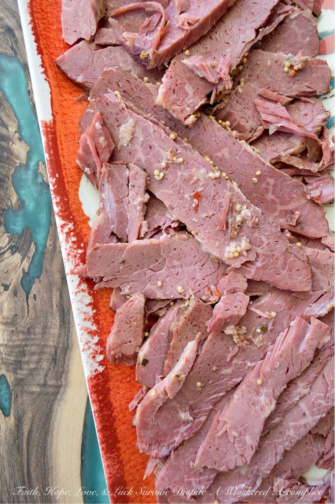 Guinness Stout Crockpot Simmered Corned Beef - Forget complicated recipes and wasted hours spent in the kitchen. With just five simple ingredients and the help of your trusty crockpot or slow cooker, you can transform a tough corned beef brisket into a melt-in-your-mouth masterpiece. This slow-cooked corned beef is simmered to perfection with Guinness Draught Stout, whole black peppercorns, sliced sweet yellow onion, and just enough water to cover the brisket, along with the traditional spice packet that comes with it. The result? A tender, juicy corned beef brisket, ready to be sliced and enjoyed with your favorite sides for a truly unforgettable meal.