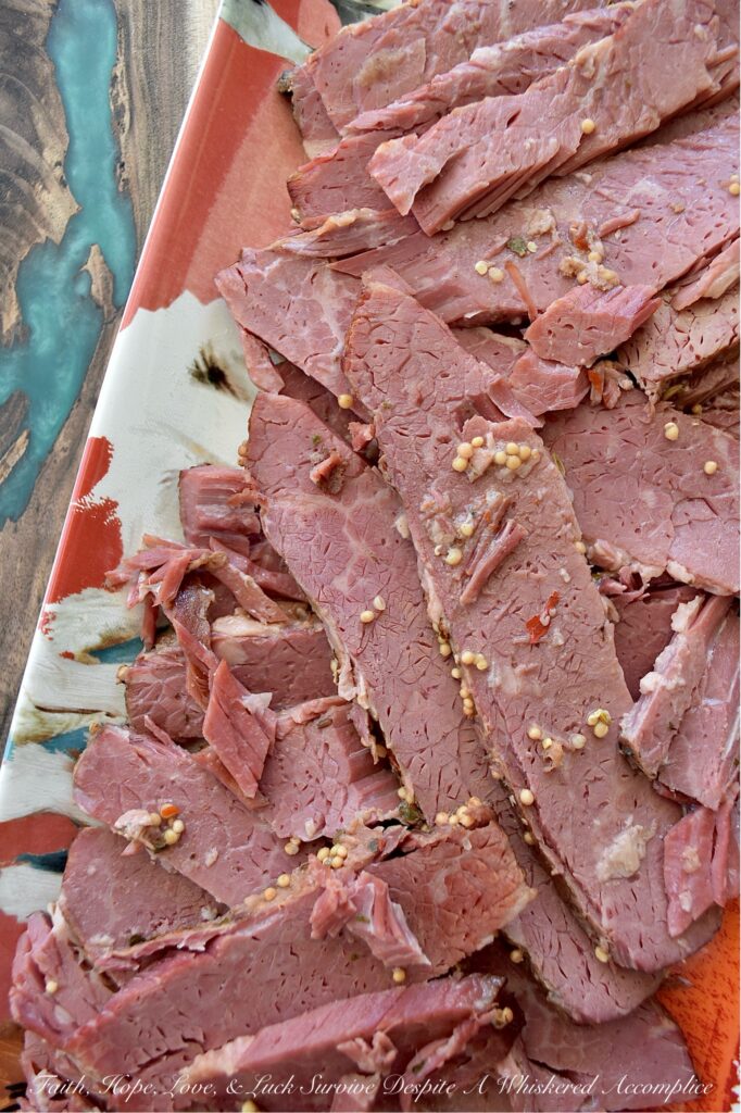 Guinness Stout Crockpot Simmered Corned Beef - Forget complicated recipes and wasted hours spent in the kitchen. With just five simple ingredients and the help of your trusty crockpot or slow cooker, you can transform a tough corned beef brisket into a melt-in-your-mouth masterpiece. This slow-cooked corned beef is simmered to perfection with Guinness Draught Stout, whole black peppercorns, sliced sweet yellow onion, and just enough water to cover the brisket, along with the traditional spice packet that comes with it. The result? A tender, juicy corned beef brisket, ready to be sliced and enjoyed with your favorite sides for a truly unforgettable meal.