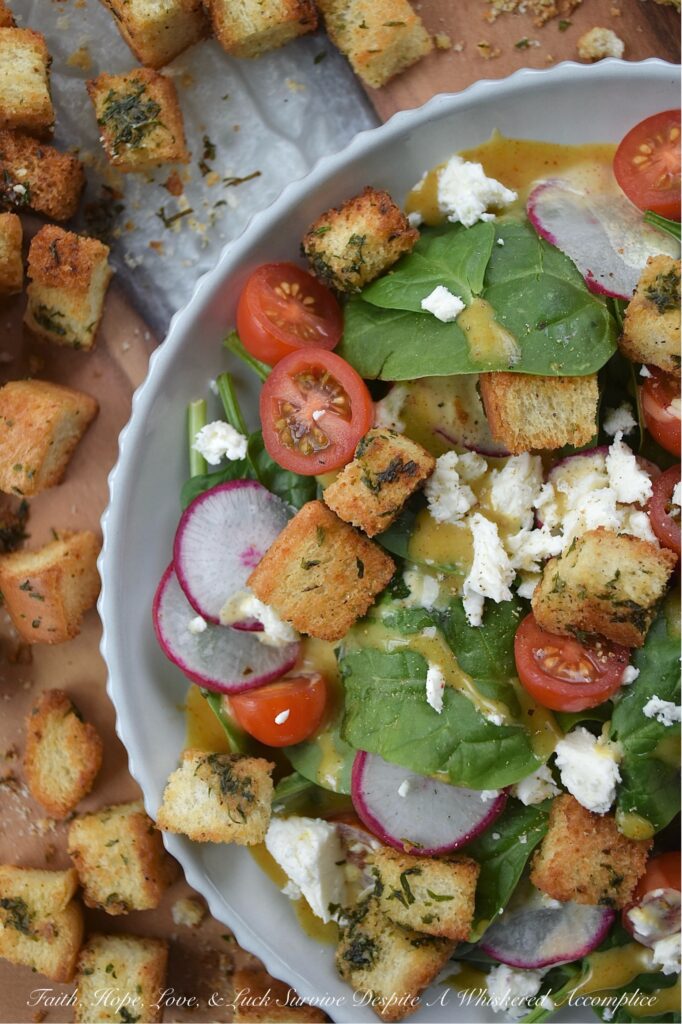 Baked Homemade Buttery Herb Croutons - Tired of the same old salads? These incredibly delicious, homemade baked croutons are buttery and flavorful while adding the perfect crunch to almost any salad. After being cubed and tossed with an herb-infused savory butter mixture, white sandwich bread is baked to golden brown crunchy toasted crouton perfection. With these irresistible homemade croutons, you'll discover there's no such thing as a boring salad.