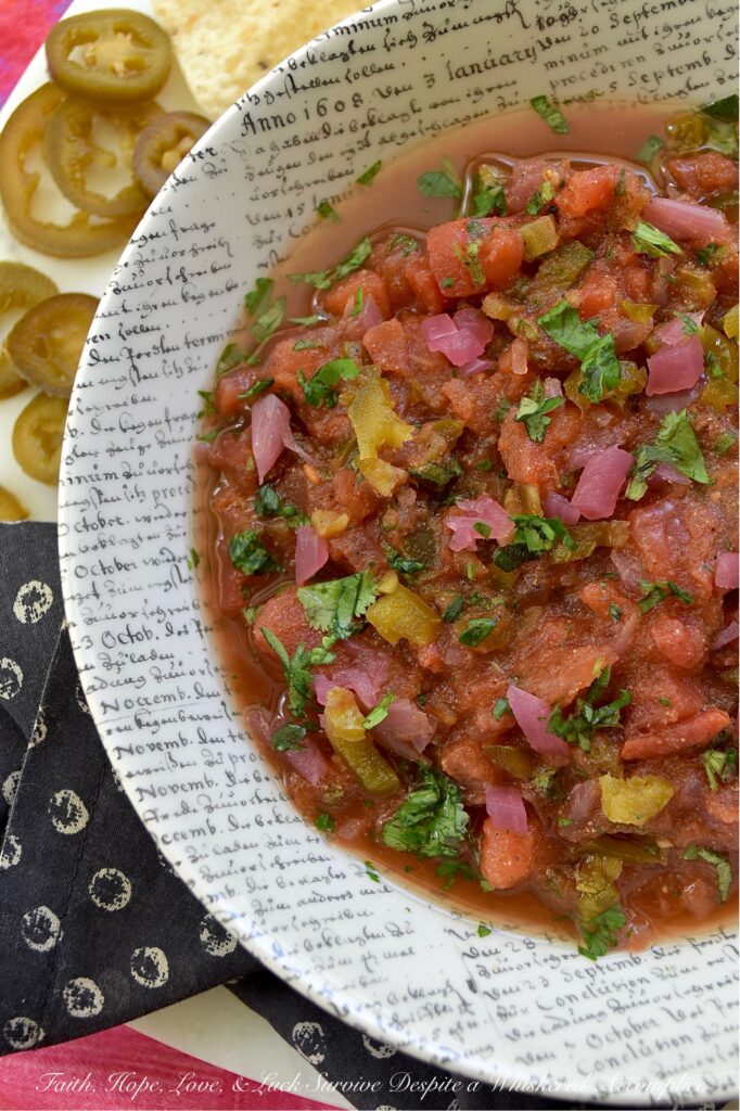 Sweet & Spicy Jalapeńo Canned Tomato Salsa - This simple recipe transforms a can of petite diced tomatoes into a vibrant, homemade salsa bursting with flavor. Savory garlic powder, onion powder, and smoky cumin are perfectly balanced by the zesty tang of pickled red onions and the delightful sweet heat of candied jalapeños. A touch of fresh cilantro and oregano adds a lovely pop of color and freshness, beautifully balancing all the flavors. Get ready to ditch your traditional, bland store-bought jar of salsa and embrace this easy-to-make homemade version that will have everyone asking for the recipe.