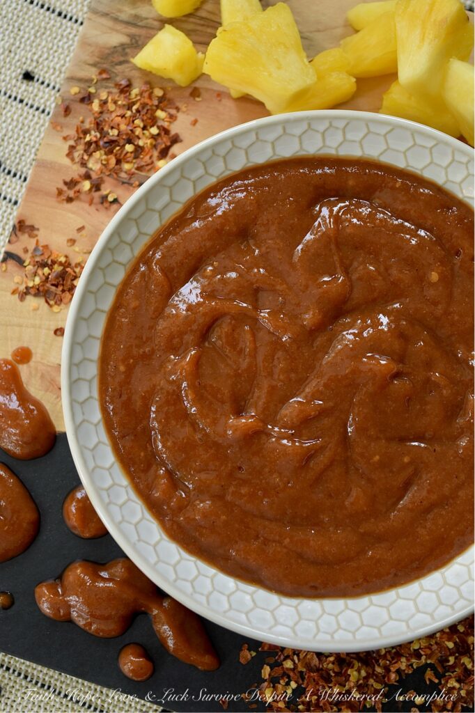 Sweet & Spicy Hawaiian Pineapple Ketchup - Tired of the same dull store-bought tomato ketchup? Prepare to transport your taste buds to a tropical island paradise with this sweet and spicy ketchup, infused with the tangy sweetness of fresh pineapple and the fiery kick of crushed red pepper flakes. A touch of savory soy sauce and subtle hints of onion, garlic, and ginger help make this Hawaiian-inspired condiment almost as versatile as it is delicious. Whether you use this ketchup to create your favorite party meatballs, as a spread with mayonnaise for ham or chicken sandwiches, as a glaze for grilled meats or seafood, or simply as a dip for grilled, roasted, or deep-fried vegetables, this sweet ketchup is sure to spice up your menu.