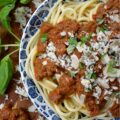 Nut-Free Basil Pesto Chunky Tomato Sauce - Forget bland, store-bought sauces. This recipe features the robust texture of canned petite diced tomatoes, slow-simmered to create a rich and hearty base. The secret ingredient? A bright and aromatic nut-free basil pesto, made with roasted salted pepitas for a unique, allergy-friendly, and satisfying twist on the classic. Perfect over a bed of pasta, draped over roasted vegetables, or as a vibrant base for your next homemade pizza, this meatless tomato sauce is packed with flavor and perfect for everyone at the table.