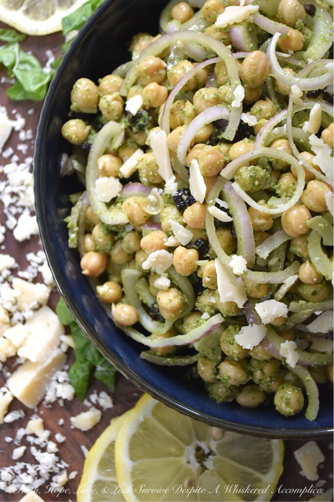 Chickpea Salad with Lemony Swiss Chard Pesto - If you're looking for a vibrant and flavorful side dish that is both easy to prepare and delicious, try this chickpea, red onion, and dried cherry salad. It's tossed in a bright, lemony pesto made with Swiss chard, salty parmesan cheese, lemon zest, and crunchy roasted pepitas. The best part? This recipe is incredibly versatile. You can easily swap out ingredients based on your preferences or what you have on hand. For example, you can use basil or spinach instead of Swiss chard, replace the pepitas with toasted pine nuts or walnuts, or substitute your favorite dried fruit for the cherries.