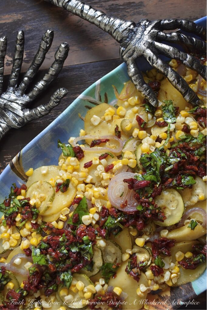 Sheet Pan Italian Olive Oil Summer Vegetables - Imagine thinly sliced potatoes, sweet onions, and tender zucchini mingling with bright corn kernels, all lightly coated with olive oil, salt, and pepper, then baked to tender, moist perfection. Once slightly cooled, these fresh summer vegetables are topped with a delicious Italian-inspired dressing made of bright olive oil, tangy balsamic vinegar, savory sun-dried tomatoes, and fragrant fresh basil. This healthy sheet pan bake demonstrates how simple ingredients, when thoughtfully combined, can create big, memorable flavors and an elegant presentation that will leave everyone eager to dig in.