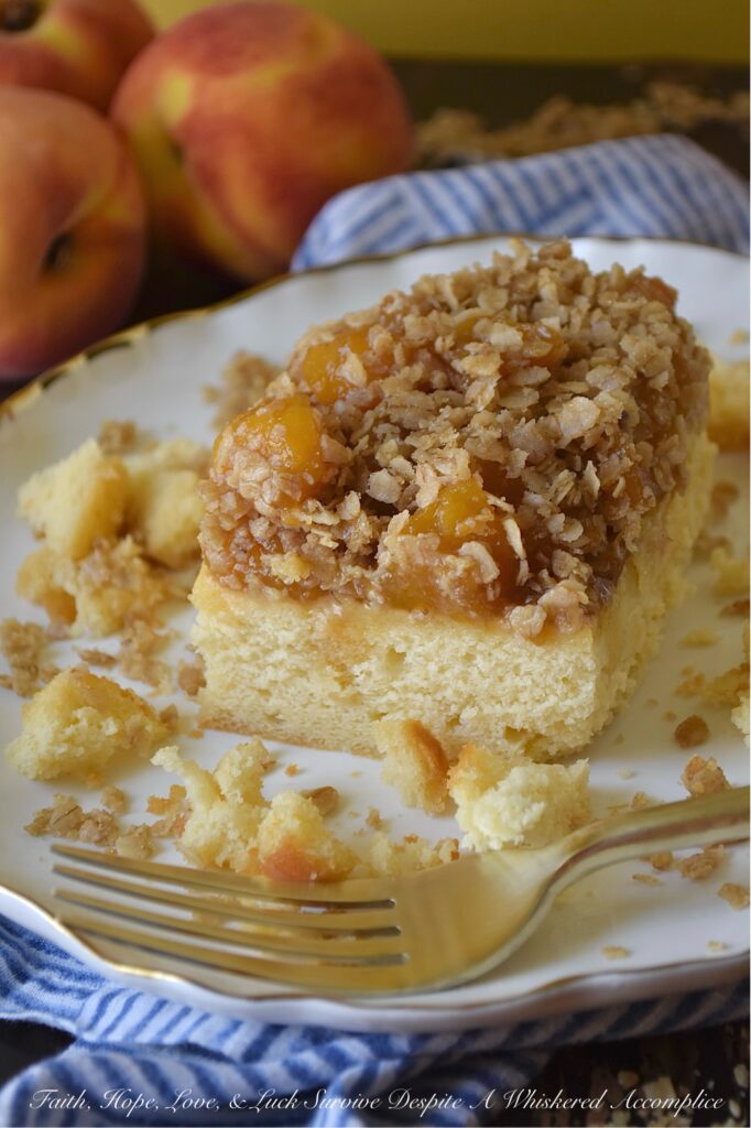 Peach Crumble Pound Cake (Cake Mix Recipe) - Say goodbye to complicated baking. This dreamy, moist pound cake is surprisingly simple to make with the help of a butter recipe yellow cake mix. Topped with luscious layers of a sweet brown sugar balsamic peach sauce and a delightful, crunchy oatmeal crumble, this peach crumble pound cake is the perfect peach recipe, whether you're using fresh, in-season peaches or enjoying a taste of summer with frozen ones. Designed to suit your needs, this cake can be baked as either two 8 x 8 square cakes or one large 9 x 13 rectangle. Whether you're hosting a backyard barbecue, attending a potluck, or looking for an irresistible, delicious fruity breakfast treat, this peach pound cake is guaranteed to be a crowd-pleaser for any occasion.