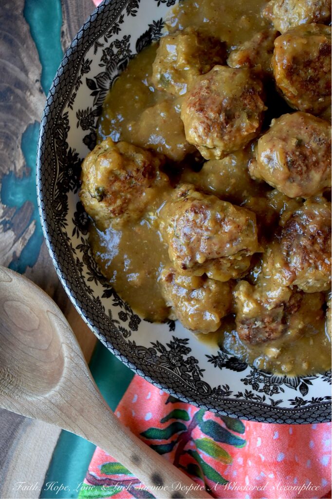 Saucy Green Chile & Beer Turkey Skillet Meatballs - Get ready to spice up your dinner routine with our Saucy Green Chile & Beer Skillet Meatballs. Tender ground turkey is gently mixed with a combination of flavorful taco seasoning, grated sweet yellow onion, a touch of cheddar cheese, and a generous helping of either fresh cilantro or fresh parsley. An egg and panko bread crumbs are also added to help bring everything together. After being browned to perfection, these savory turkey meatballs are then simmered in a unique and utterly delicious sauce combining beer and zesty green chile enchilada sauce. Served over rice, pasta, or mashed potatoes, these comforting, saucy stove-top skillet meatballs promise a family-friendly meal that is as easy to prepare as it is to enjoy.