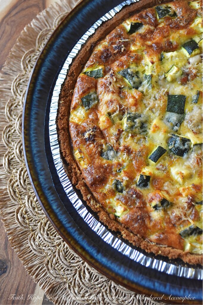 Italian Zucchini & Sausage Graham Cracker Quiche - Forget rolling out a pie crust or blind baking; our secret weapon for an effortless homemade quiche is a store-bought graham cracker crust. Yes, you read that right. This unexpected quiche base pairs perfectly with salty Parmesan cheese, flavorful browned sausage, tender diced zucchini, and a thick, creamy egg filling seasoned with an Italian herb seasoning mix. Whether you're searching for a sweet and savory breakfast idea, a show-stopping brunch recipe, or a uniquely satisfying idea for a weeknight dinner, this easy-to-assemble quiche is about to become your new secret weapon.