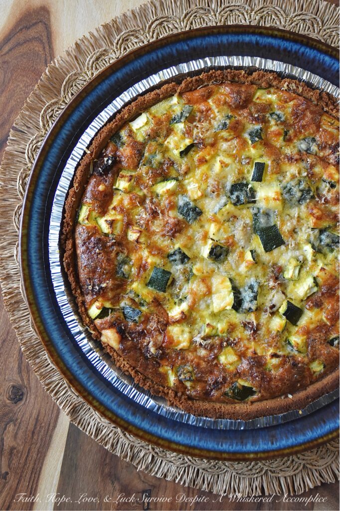 Italian Zucchini & Sausage Graham Cracker Quiche - Forget rolling out a pie crust or blind baking; our secret weapon for an effortless homemade quiche is a store-bought graham cracker crust. Yes, you read that right. This unexpected quiche base pairs perfectly with salty Parmesan cheese, flavorful browned sausage, tender diced zucchini, and a thick, creamy egg filling seasoned with an Italian herb seasoning mix. Whether you're searching for a sweet and savory breakfast idea, a show-stopping brunch recipe, or a uniquely satisfying idea for a weeknight dinner, this easy-to-assemble quiche is about to become your new secret weapon.