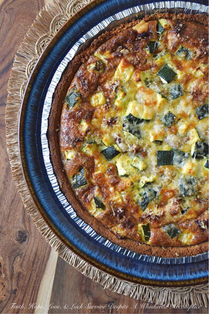 Italian Zucchini & Sausage Graham Cracker Quiche - Forget rolling out a pie crust or blind baking; our secret weapon for an effortless homemade quiche is a store-bought graham cracker crust. Yes, you read that right. This unexpected quiche base pairs perfectly with salty Parmesan cheese, flavorful browned sausage, tender diced zucchini, and a thick, creamy egg filling seasoned with an Italian herb seasoning mix. Whether you're searching for a sweet and savory breakfast idea, a show-stopping brunch recipe, or a uniquely satisfying idea for a weeknight dinner, this easy-to-assemble quiche is about to become your new secret weapon.