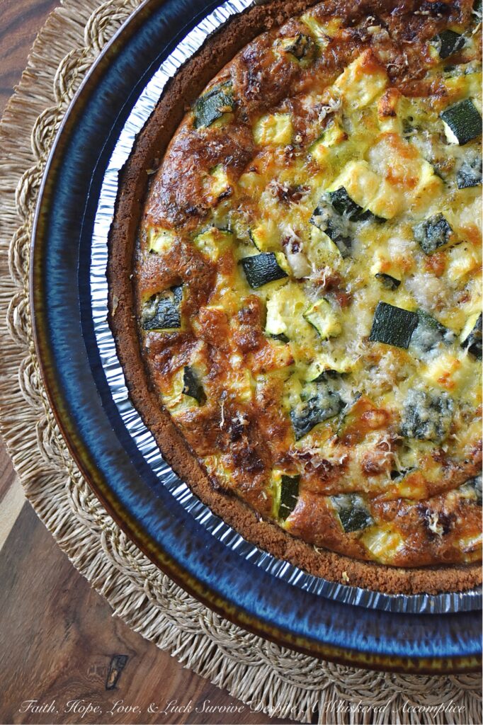 Italian Zucchini & Sausage Graham Cracker Quiche - Forget rolling out a pie crust or blind baking; our secret weapon for an effortless homemade quiche is a store-bought graham cracker crust. Yes, you read that right. This unexpected quiche base pairs perfectly with salty Parmesan cheese, flavorful browned sausage, tender diced zucchini, and a thick, creamy egg filling seasoned with an Italian herb seasoning mix. Whether you're searching for a sweet and savory breakfast idea, a show-stopping brunch recipe, or a uniquely satisfying idea for a weeknight dinner, this easy-to-assemble quiche is about to become your new secret weapon.